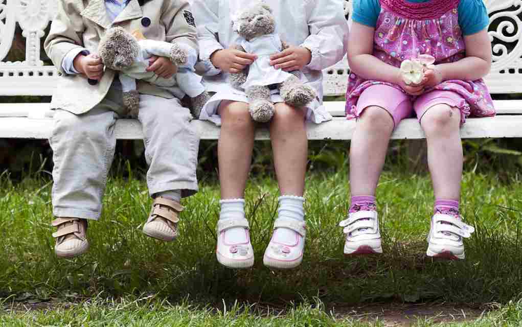 children sitting on park bench in louth