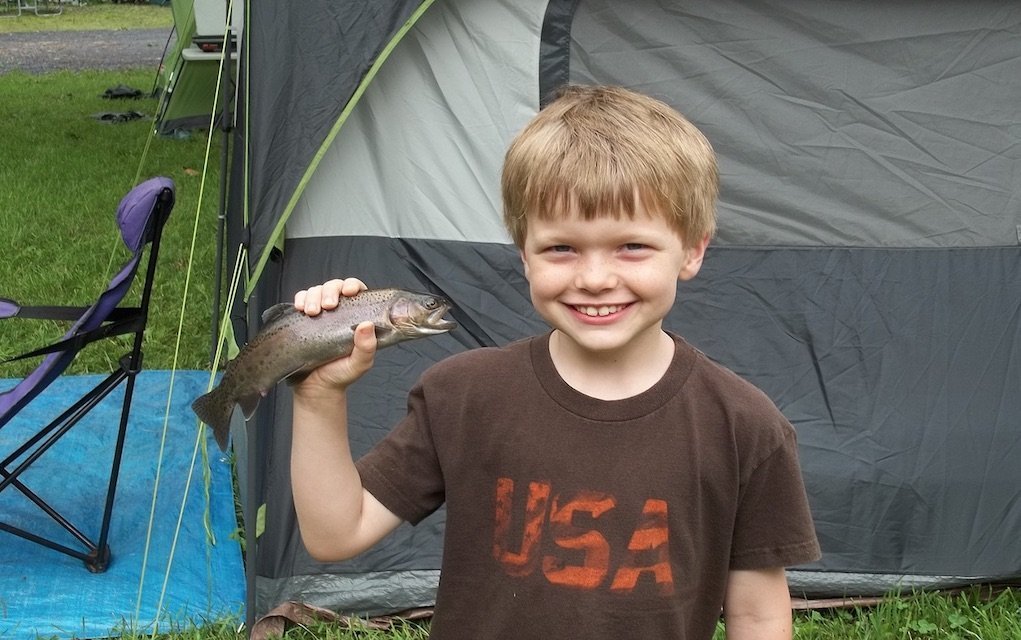 camping boy with fish Family friendly campsites in Ireland with activities